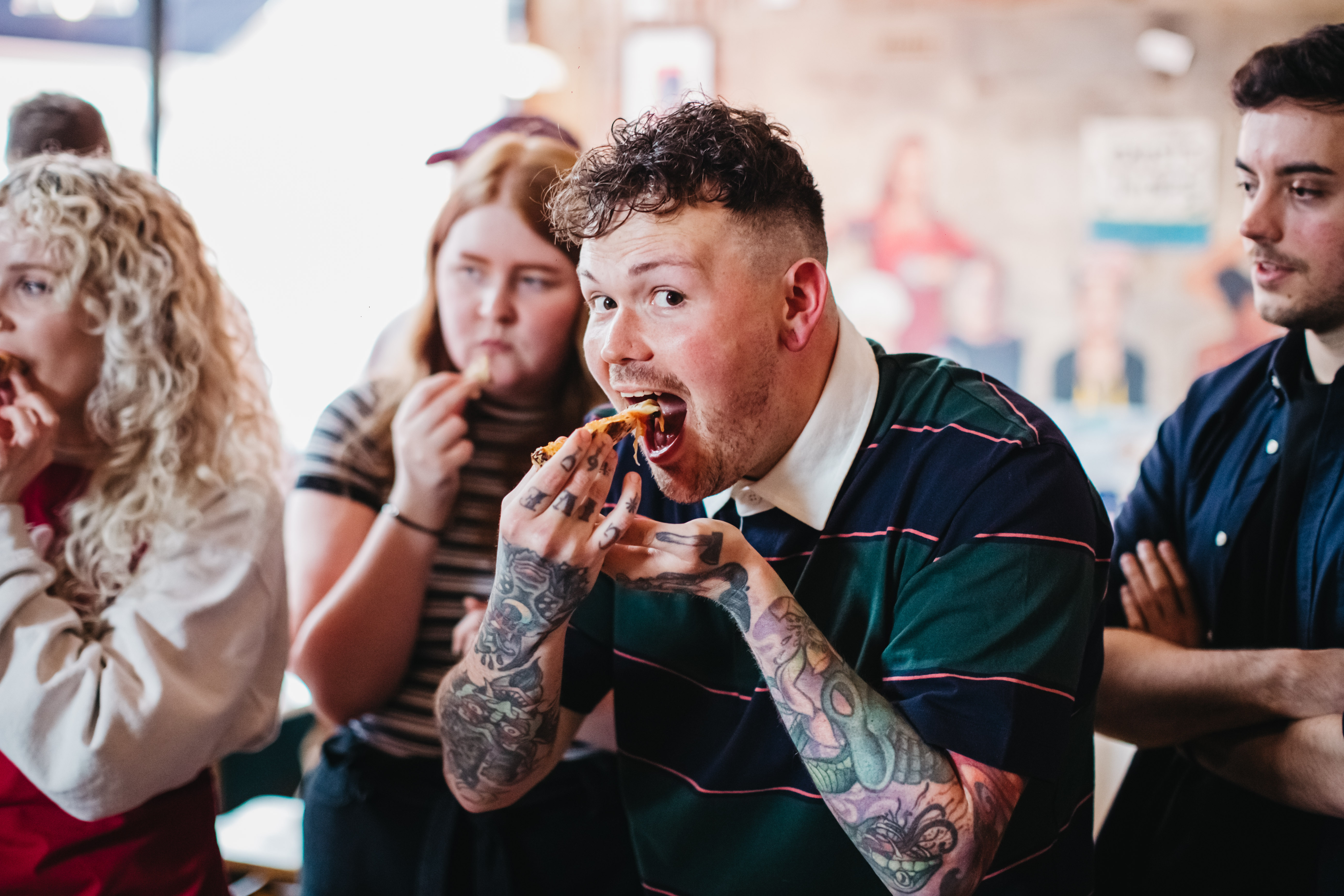 A man is eating a slice of homemade pizza