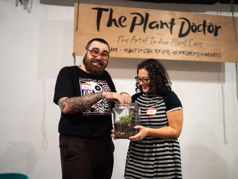 A couple holding a DIY terrarium. 