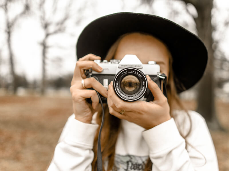 A person focusing a camera getting ready to take a picture