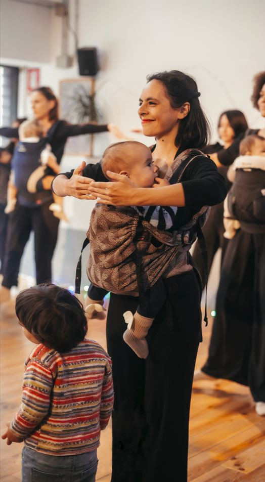 Woman with baby at a barre dance class