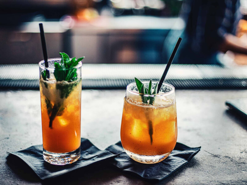 Two delicious cocktails placed on top of napkins