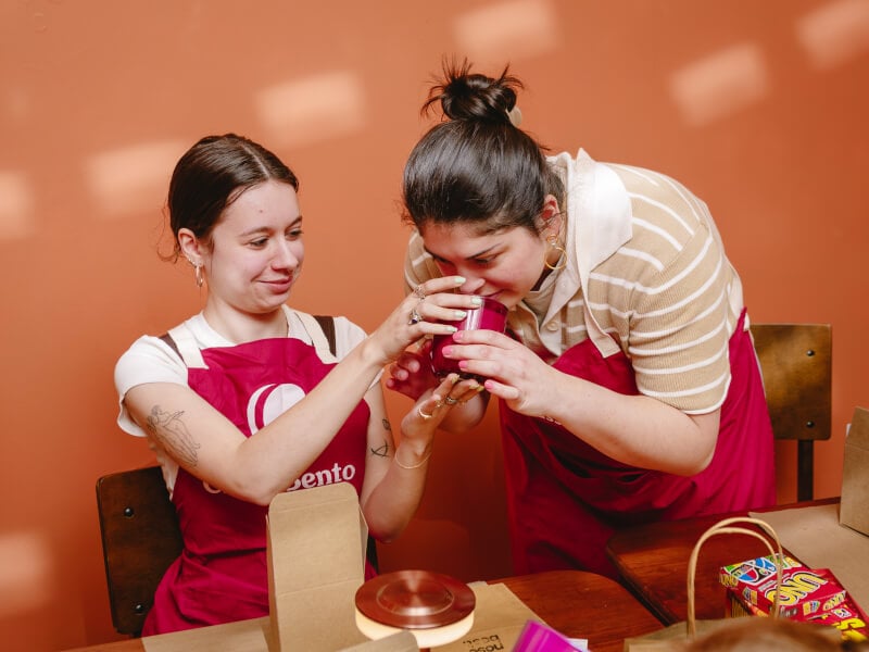 Woman smelling a candle in a candle making workshop
