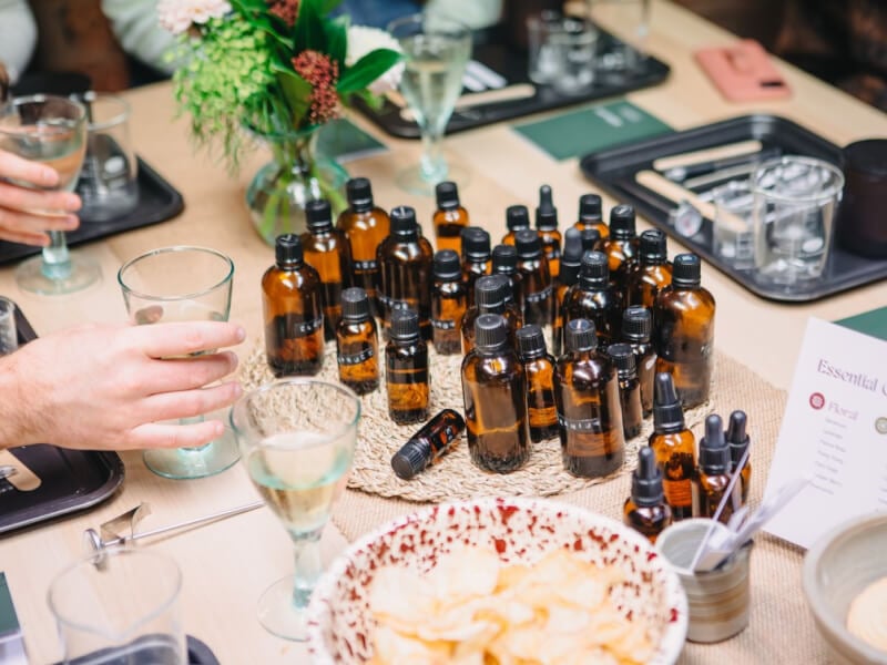 Table with bottles of essential oils for candle making