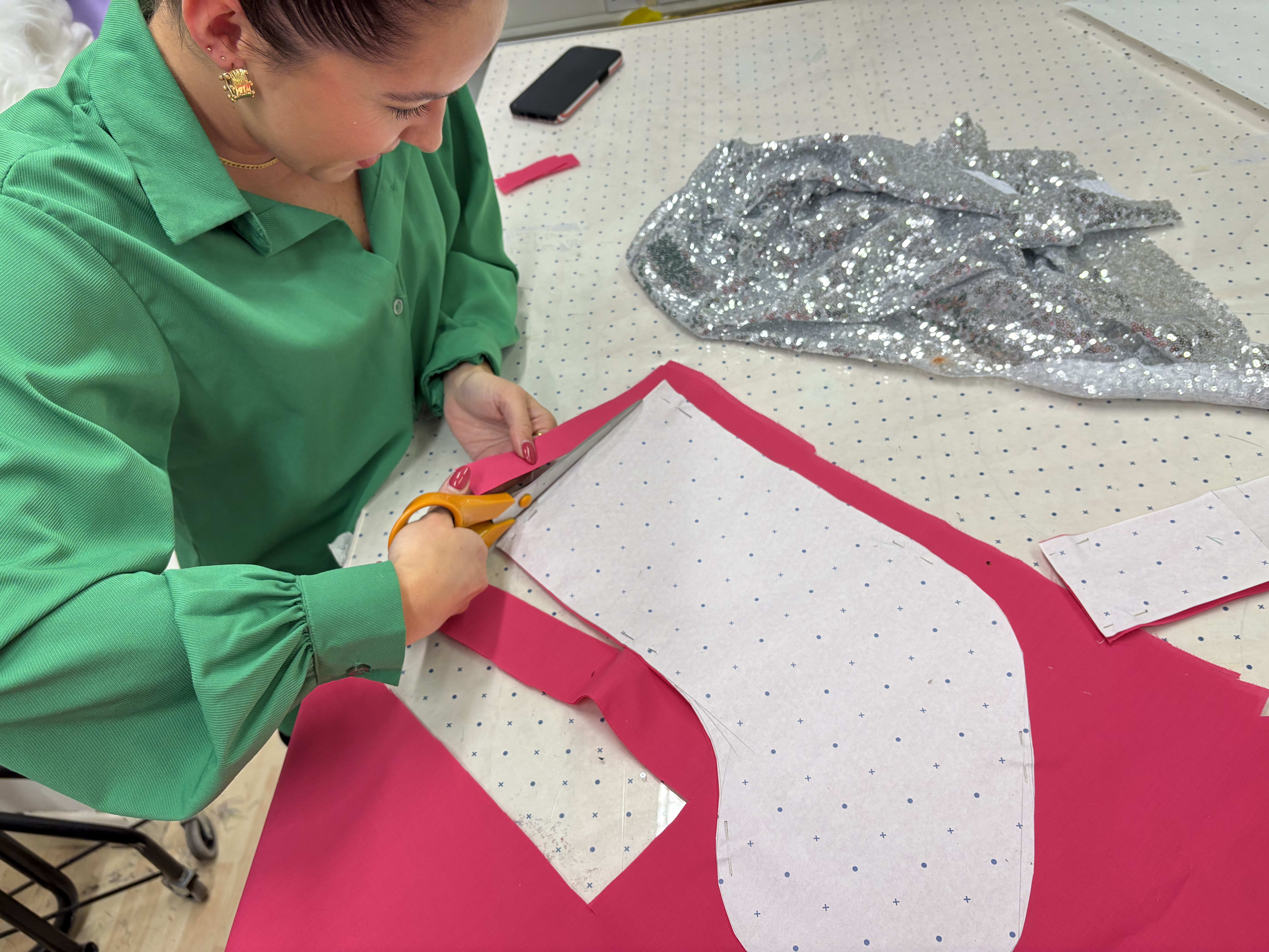 A person sewing a Christmas stocking on a sewing machine