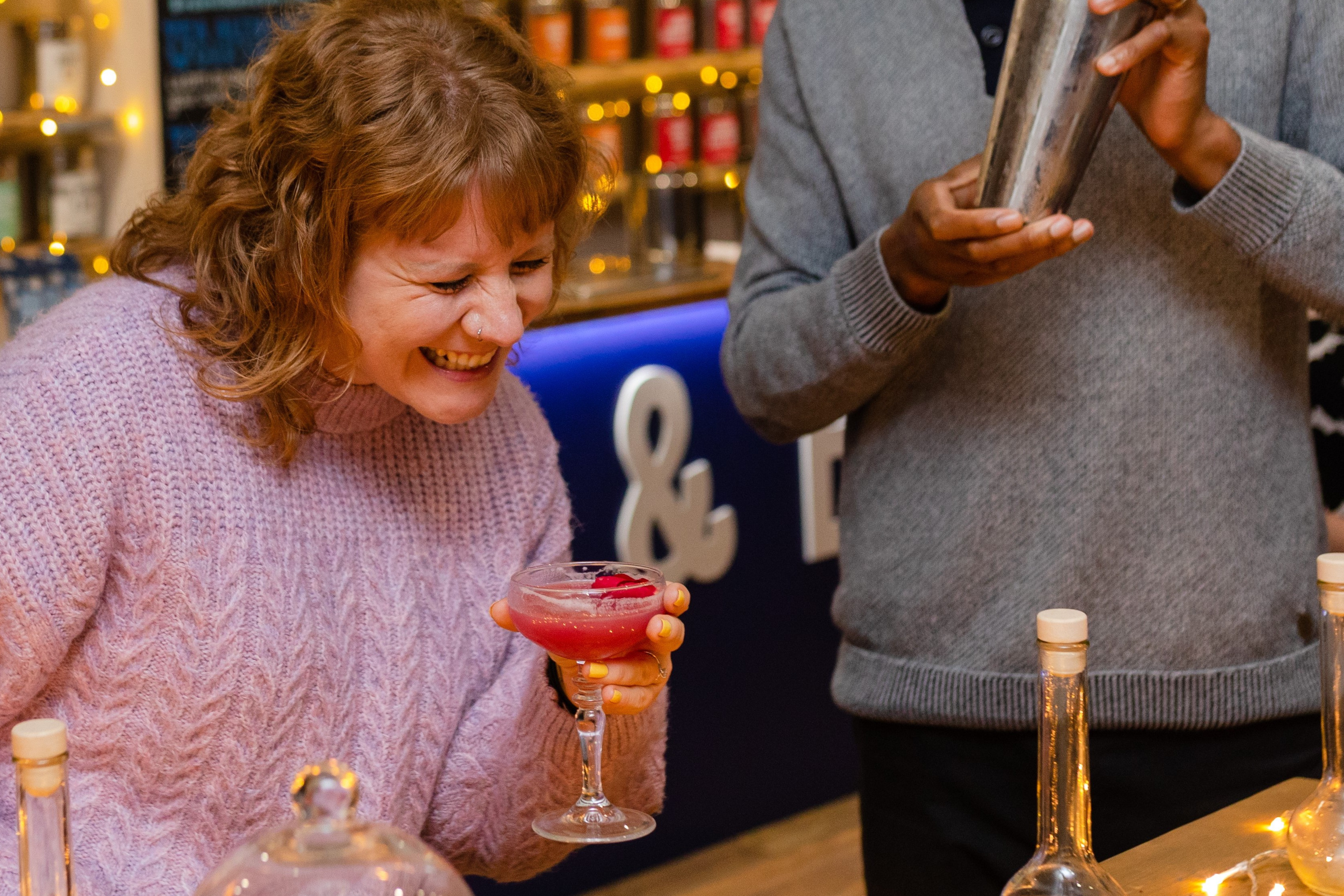 Action shot of people having fun at a cocktail making class