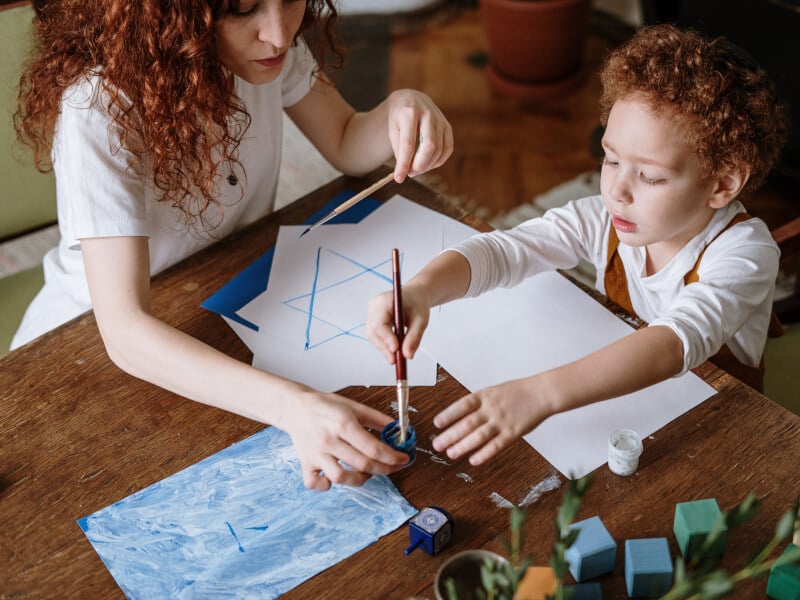 A mother and child paint together