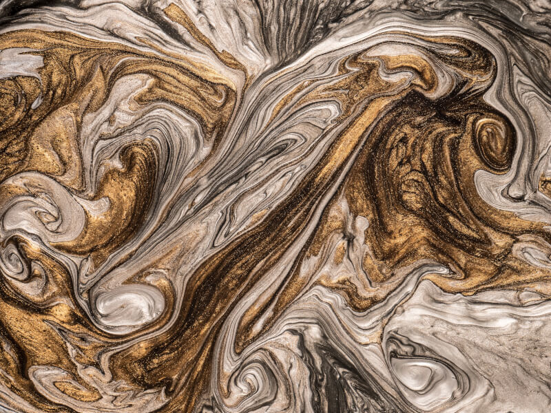 A bronze, silver, brown and gold piece of acrylic poured art in swirly patterns