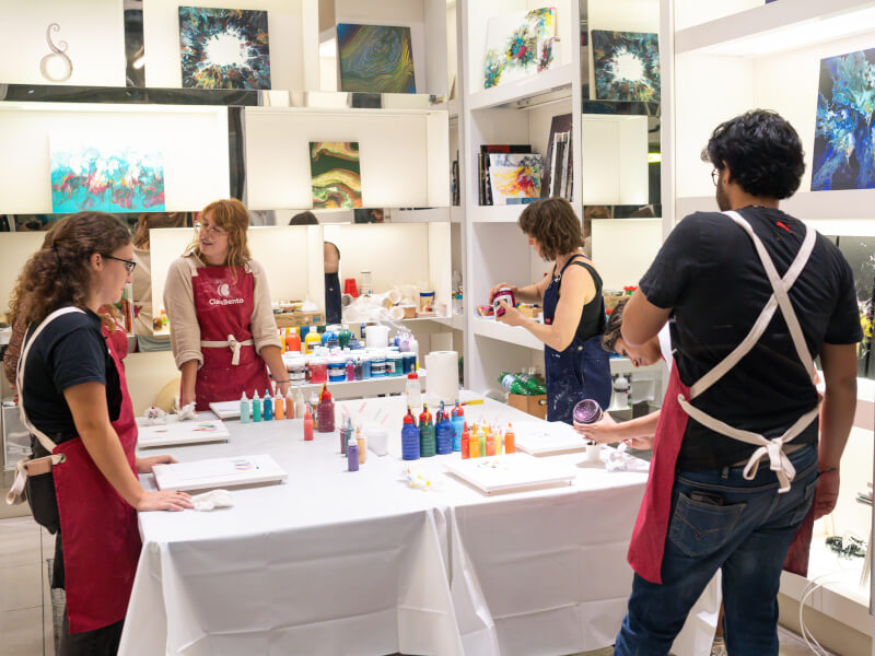 People stood around a table at an art class in London.