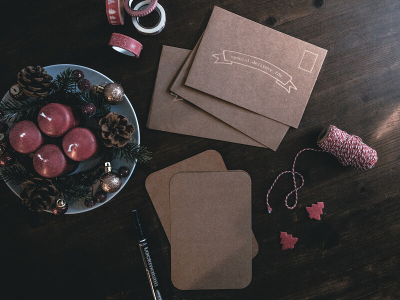 A flat lay of Christmas craft materials and gift tags