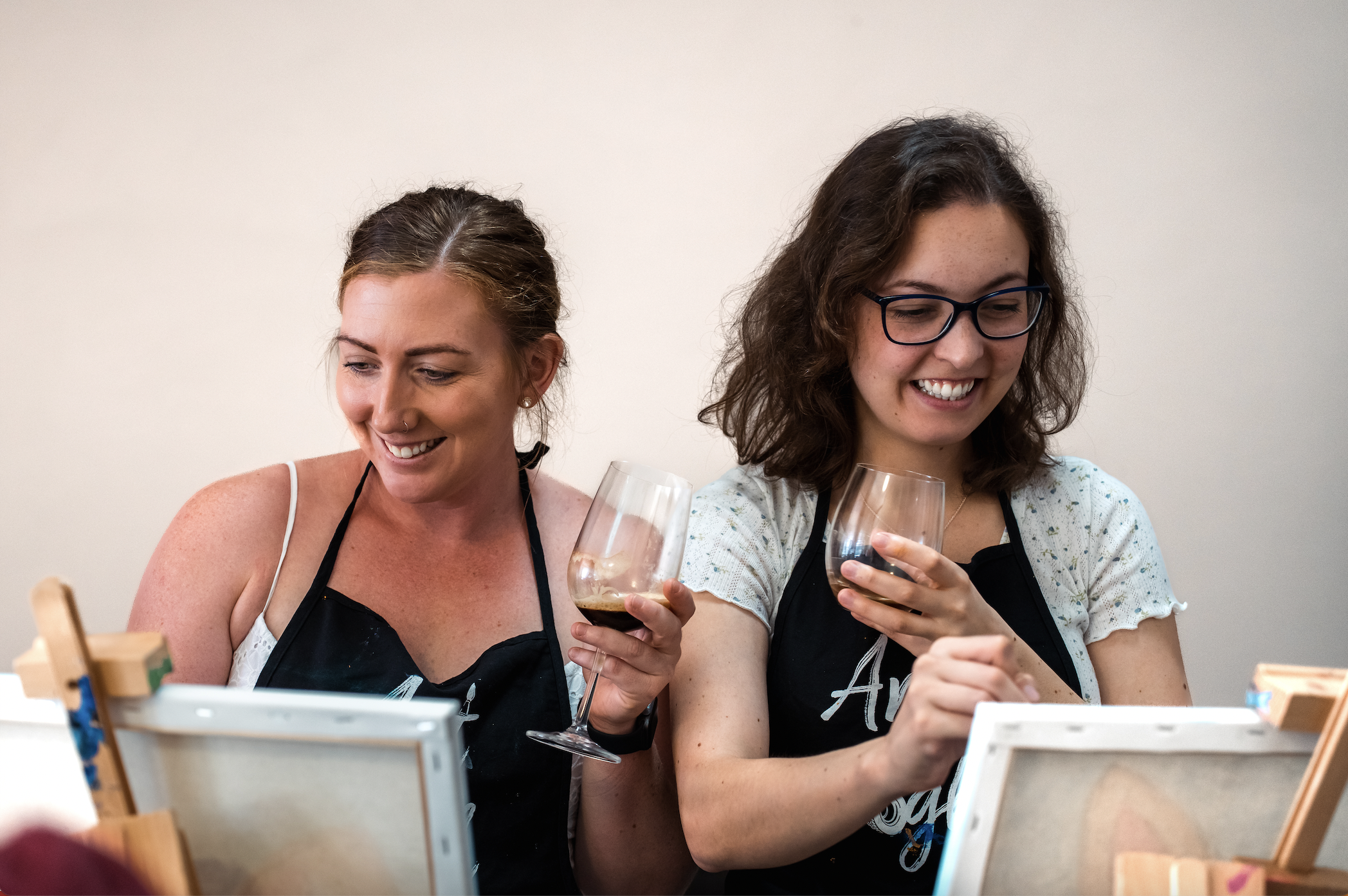 Two students at a paint and sip class