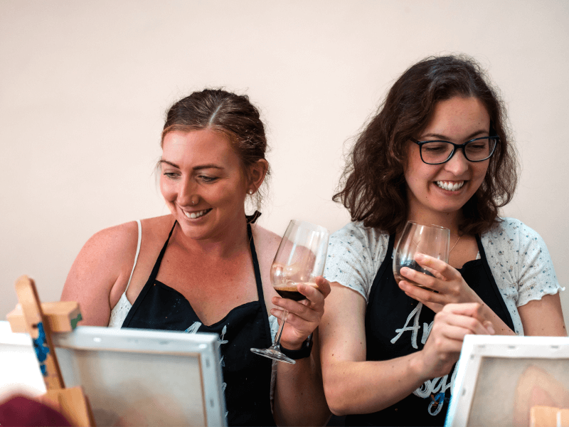 Two people at a sip and paint workshop