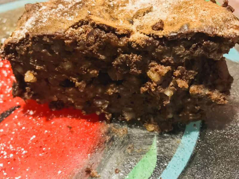 A slice of Spanish chocolate rice cake on a red plate