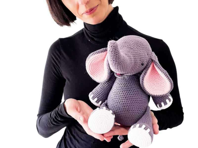 Anora of Elendipity, holding a crocheted elephant