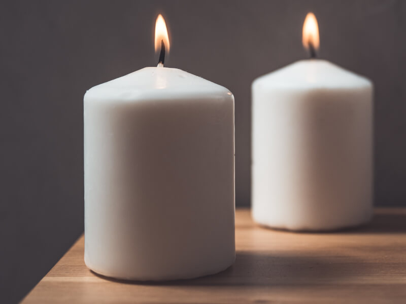 Two lit large candles