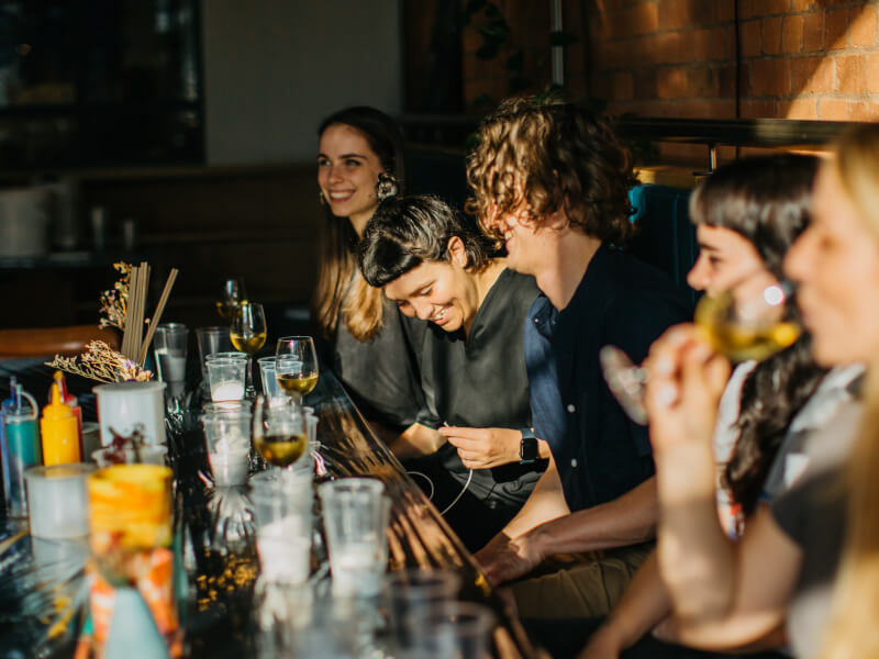 A group of people at a craft class smiling.