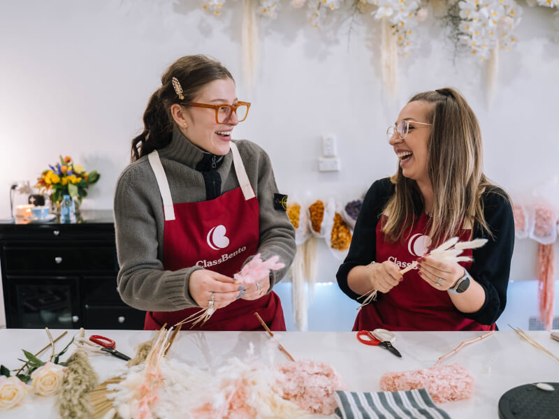 Two smiling women in a floristry class