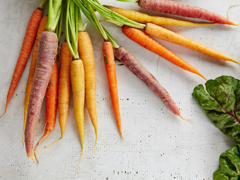 Brightly coloured organic carrots ready to use in an online cooking class.