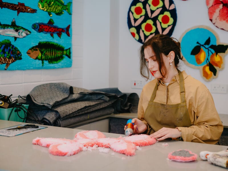 Woman in a tufting class