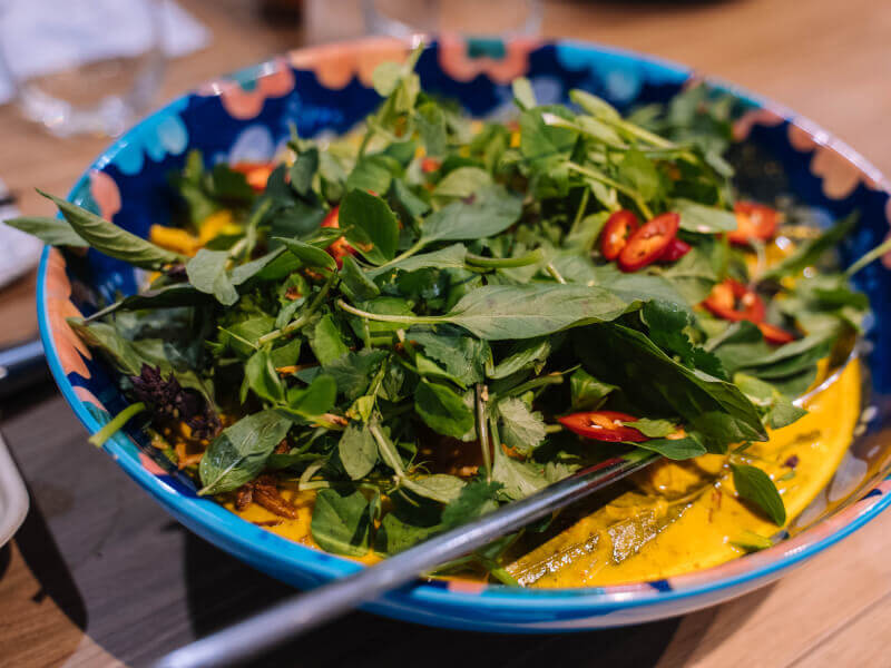 A plate of salad sits on a table