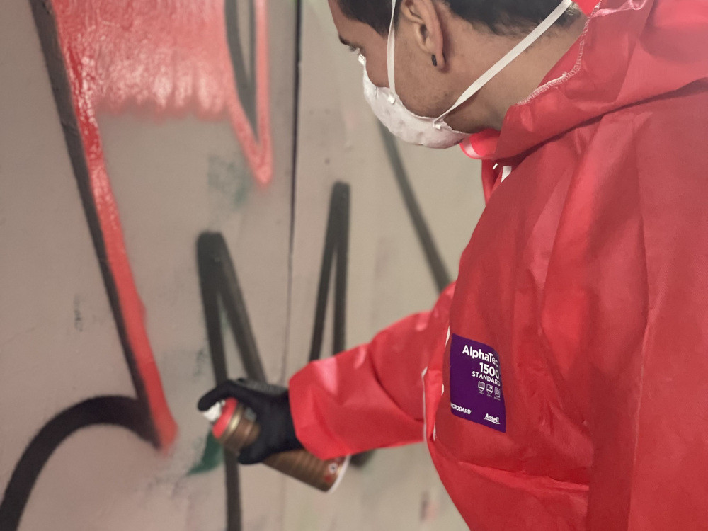 A person using a reference image to make street art
