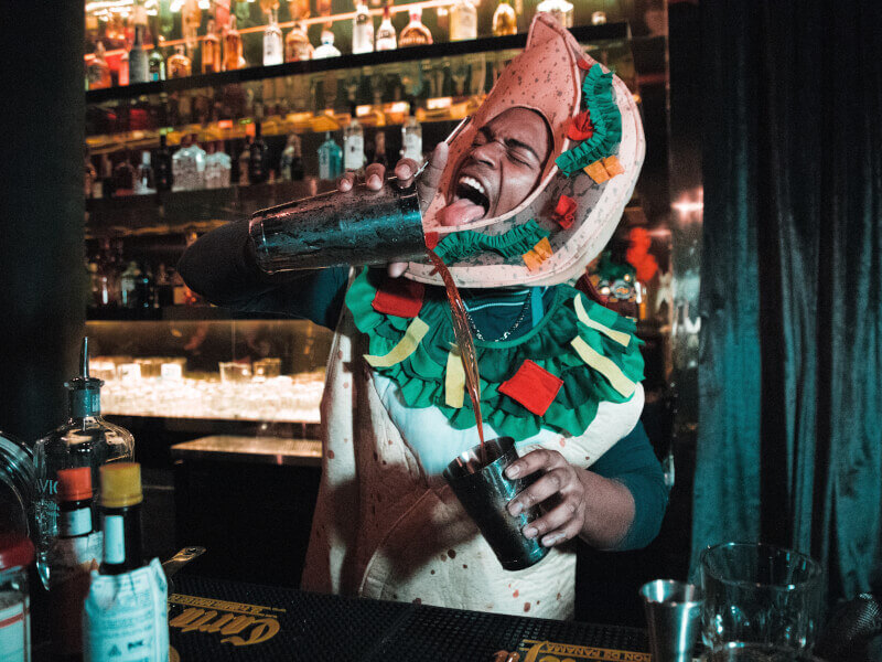 A person demonstrating how to make cocktails