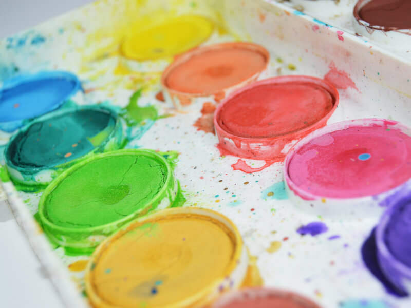 A colourful paint palette, ready for an online painting class. 