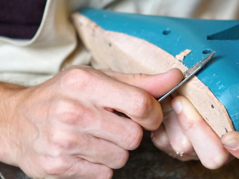 close up of a man handmaking shoes