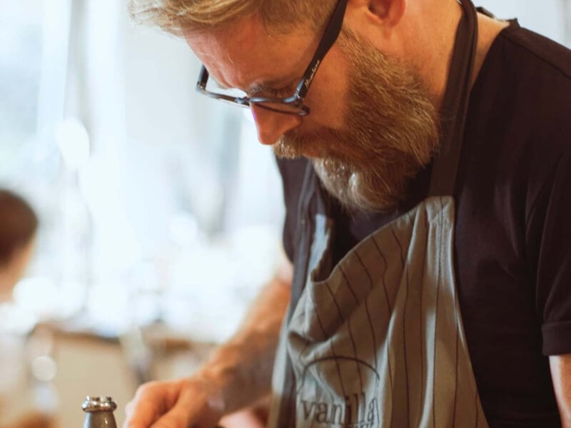 A man using jewellery making tools to make a silver ring 