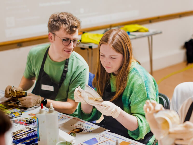 A couple working with pottery in a kintsugi class