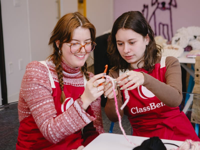 Two women crocheting/knitting in a class