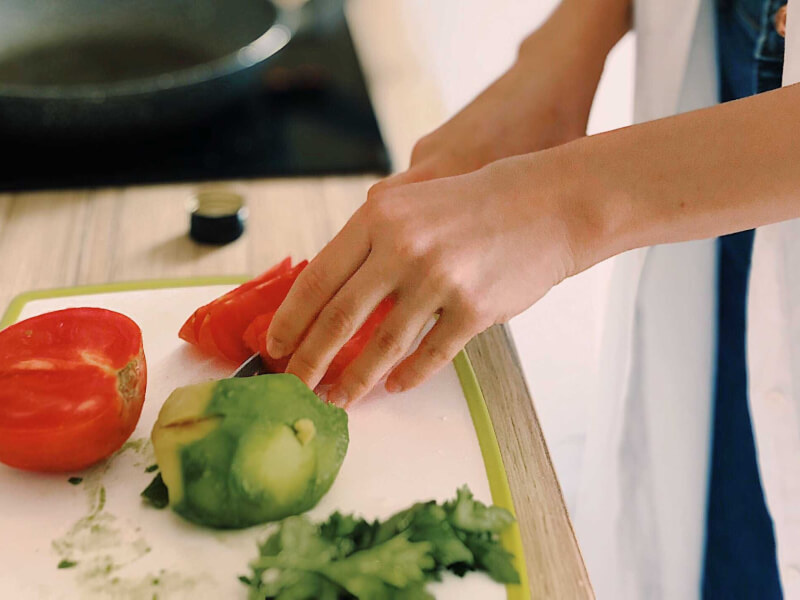 A person chopping vegetables