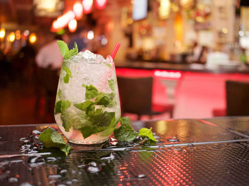 A cocktail decorated with green herbs