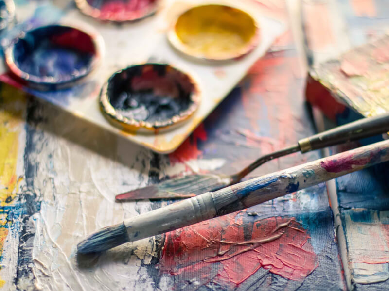 A paint brush and other equipment covered in dried paint