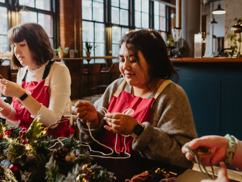 A woman making a macrame decoration