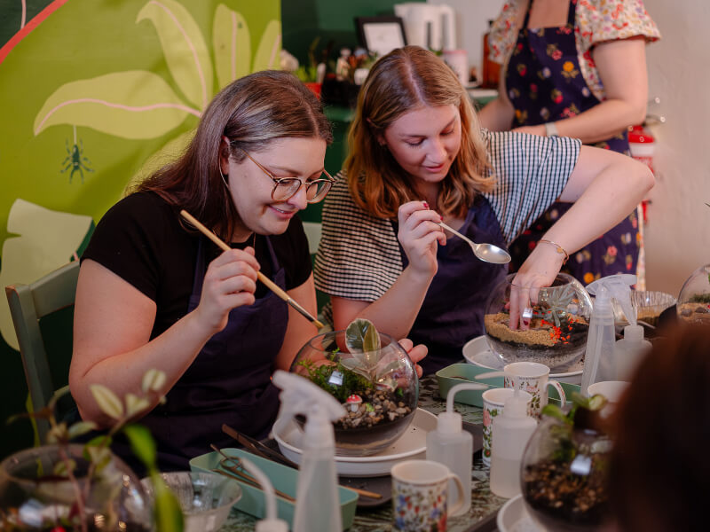 A group of friends at a terrarium making workshop