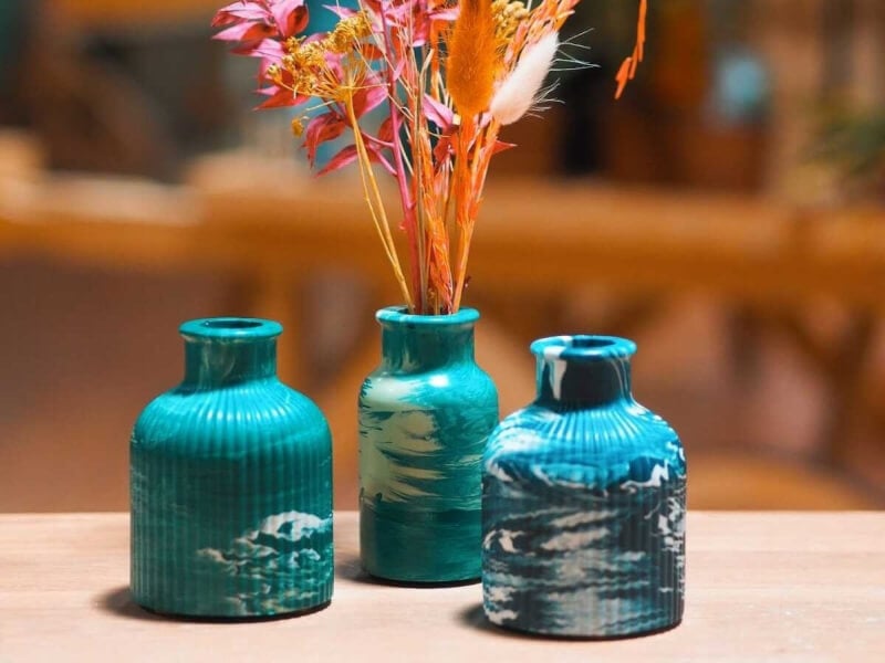 A selection of three aqua and white marbled mini vases 