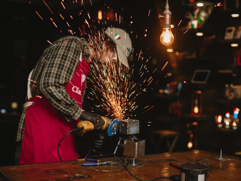 Man making sparks in a metalworking class