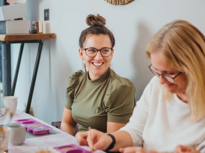 Two women are making eco friendly soap and smiling