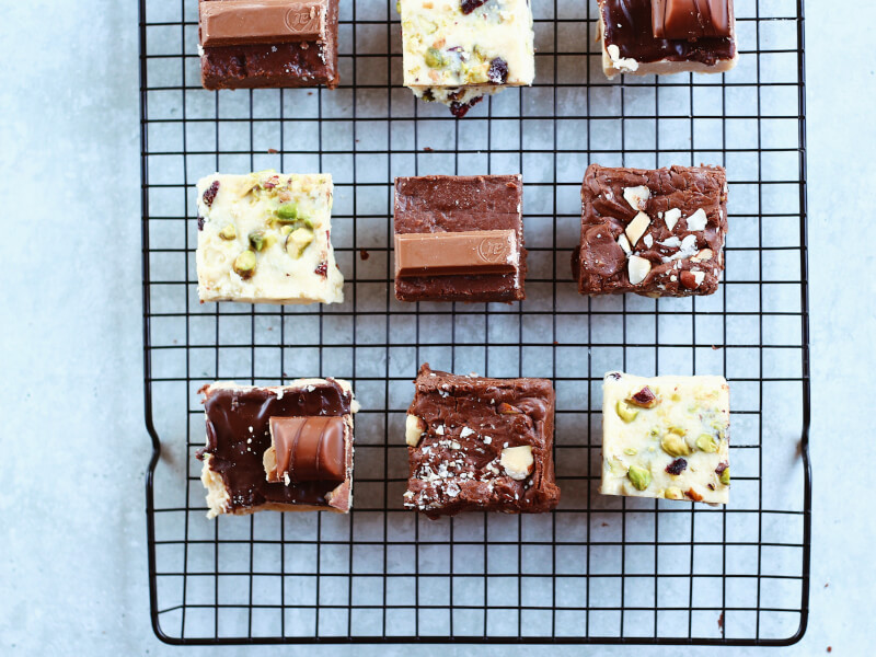 Homemade chocolate and nut treats on a cooling rack.