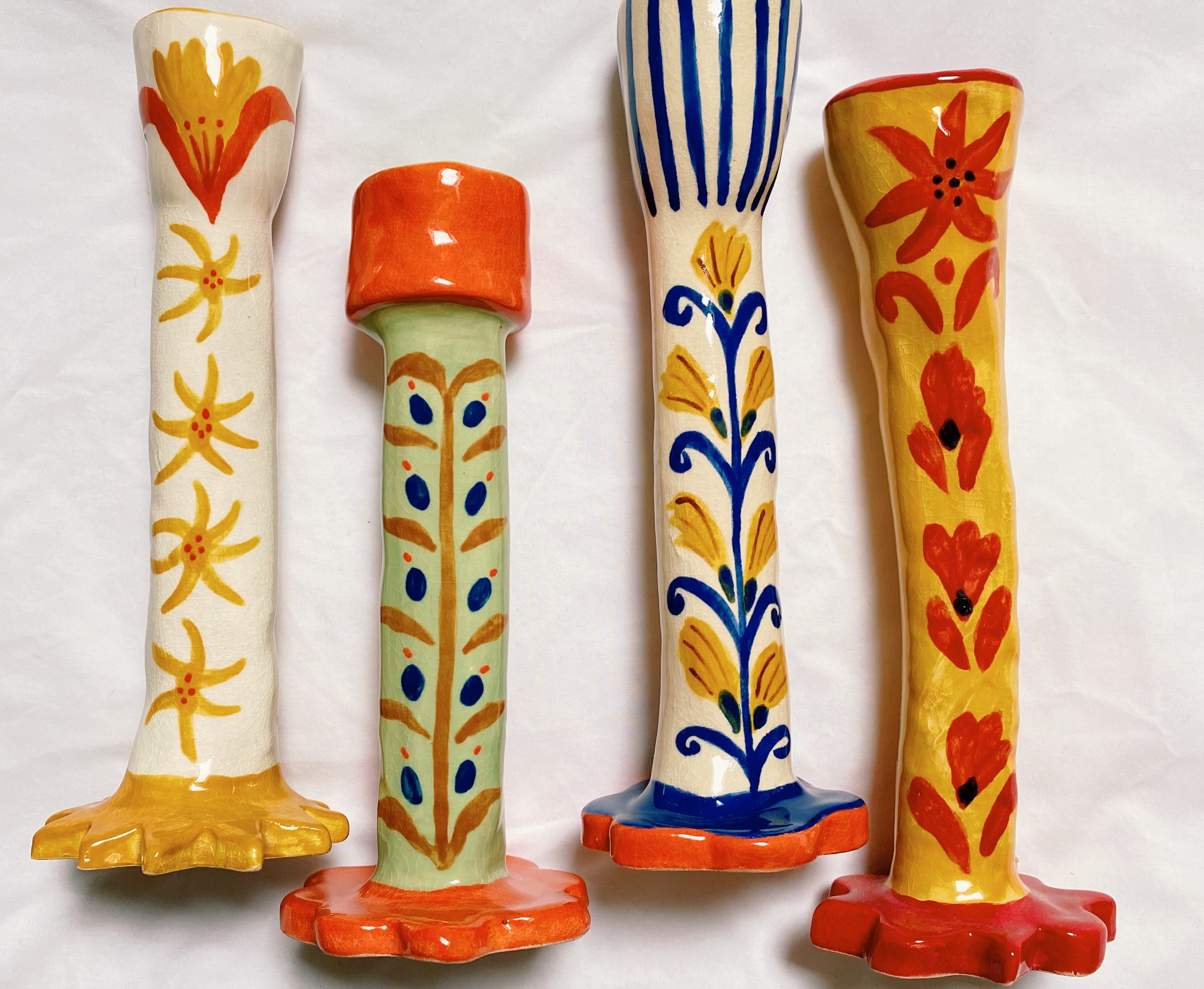 A set of painted ceramic candlesticks