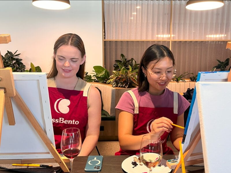 Couple of women painting on canvases in a painting class