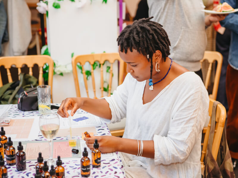 Woman mixing oils in a custom perfume making class