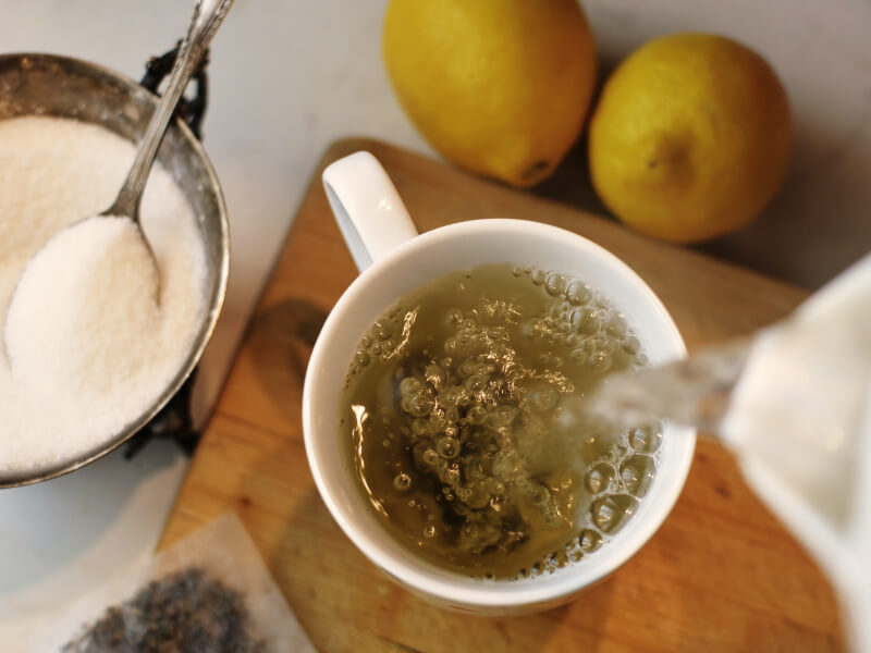 Pouring boiling water into a cup for tea making.
