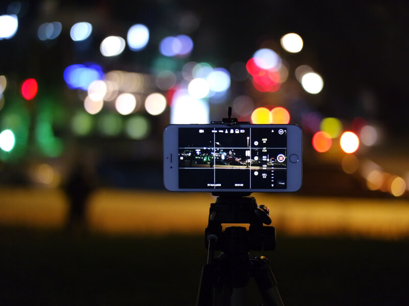A phone camera with a grid on screen on a tripod. 