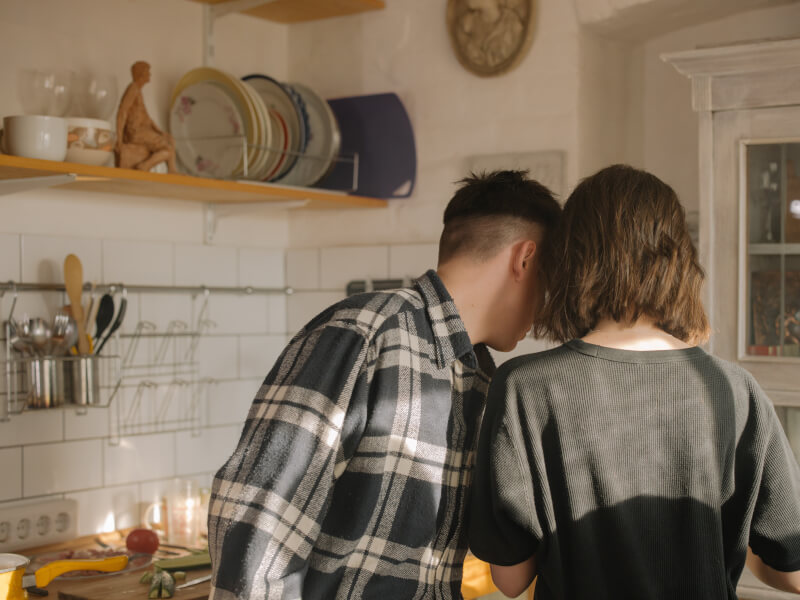 A young couple checking the instructions during a cooking class online.