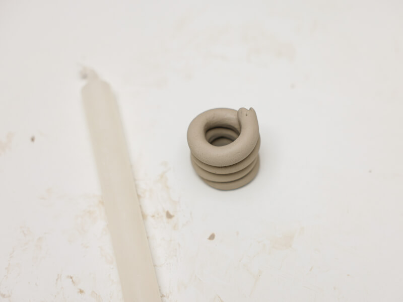 Clay moulded into a coil shape.