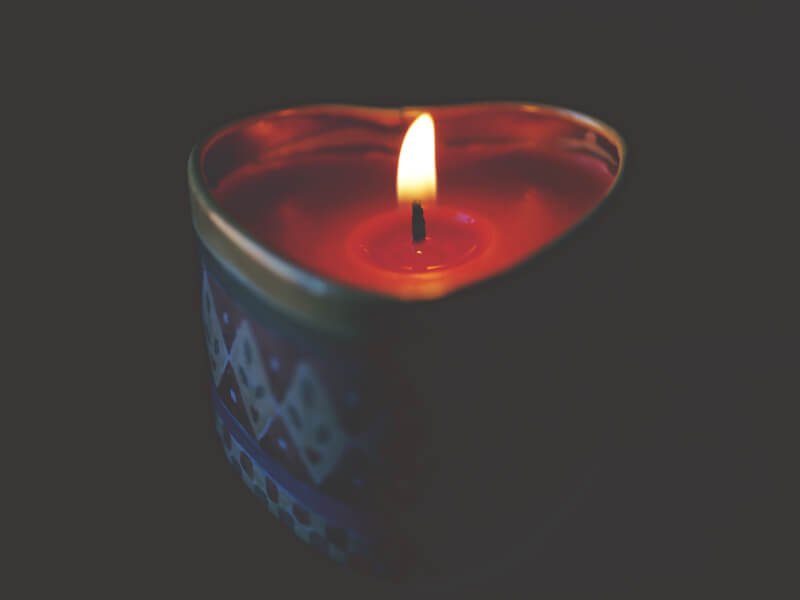 Soy candle alight in a heart-shaped, hand decorated tin. 