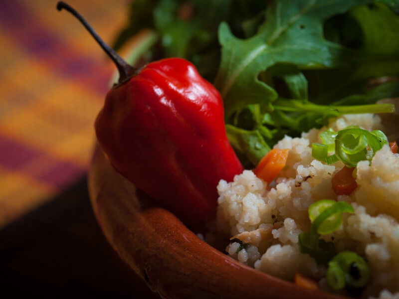 A bowl of rice topped with a chilli and vegetables made at a cooking class. 