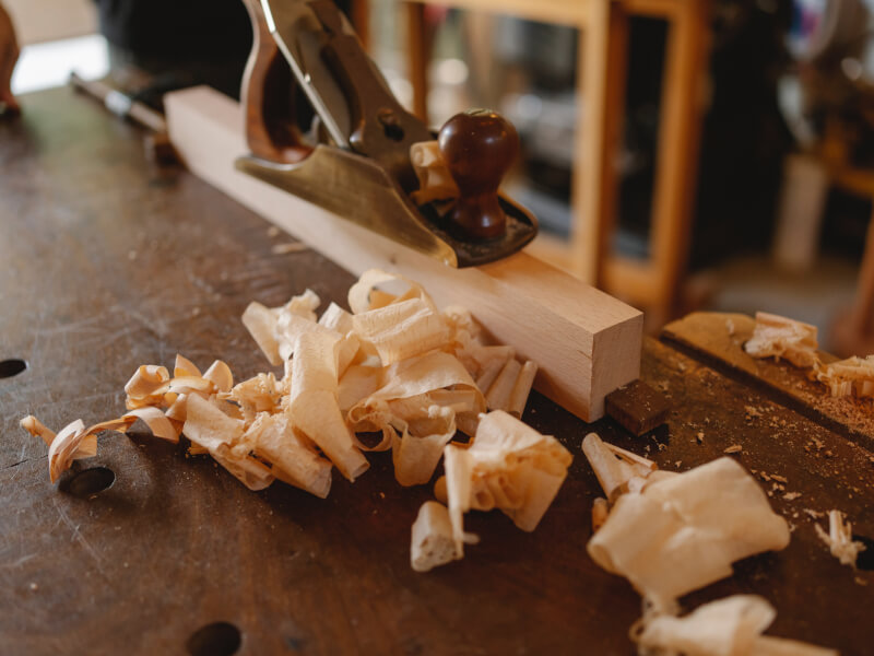 shavings from someone doing wood carving on light timber.