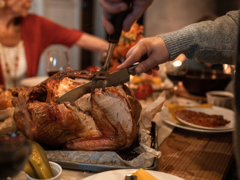 A turkey being carved at a Christmas party.